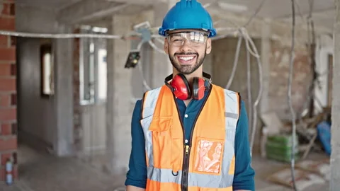 Young hispanic man builder smiling confident wearing hardhat at constructio.. 스톡 동영상 245568050