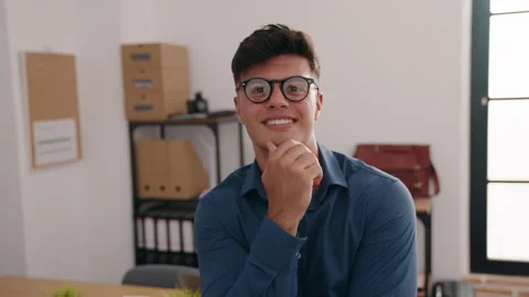 Young hispanic man business worker smiling confident wearing glasses at offic Video stock 220149088
