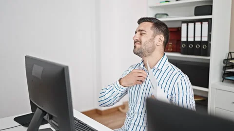 Young hispanic man business worker sweating using document as a hand fan at.. Video stock 243490211