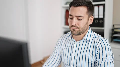 Young hispanic man business worker using computer working at office Stock Footage 243490215