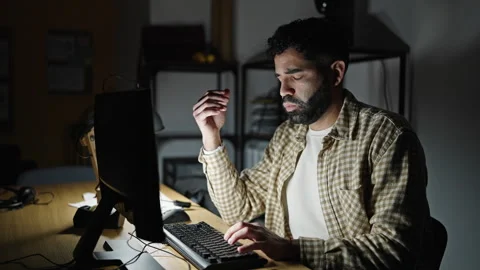 Young hispanic man business worker using computer stressed at office Video stock 245046227