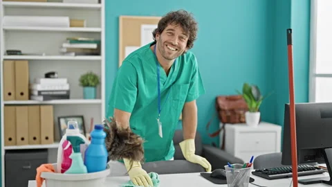 Young hispanic man cleaning table with a cloth doing thumb up gesture at offi Video stock 245045199