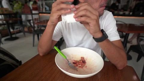 Young hispanic man cleans his hands and mouth with a napkin Video stock 164367476