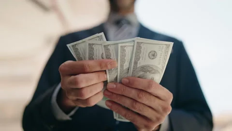 Young hispanic man executive counting dollars at street Stock Footage 197488883