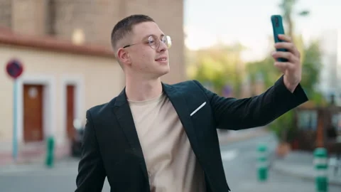 Young hispanic man executive make selfie by the smartphone at street Stock Footage 171789270
