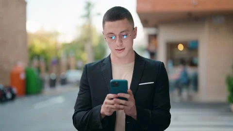Young hispanic man executive using smartphone at street Stock Footage 170634068