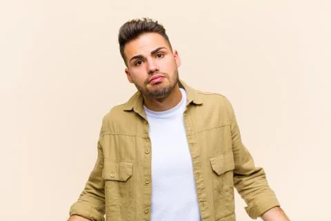 Young hispanic man feeling clueless and confused, having no idea, absolutely  Stock Photos