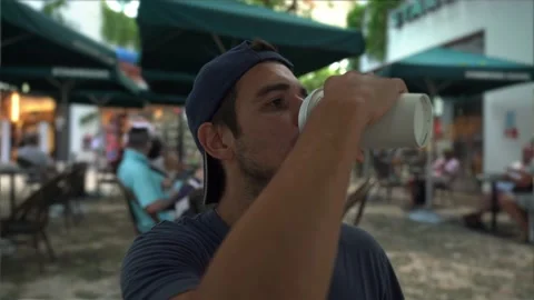 Young hispanic man with hat drinks coffee Stock Footage 170158262