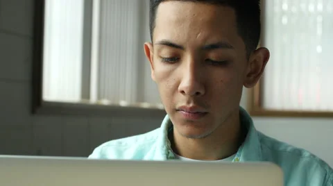 Young Hispanic man at laptop 動画素材 49658345