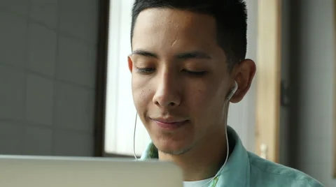 Young hispanic man looking at computer screen, happy Stock Footage 49660533