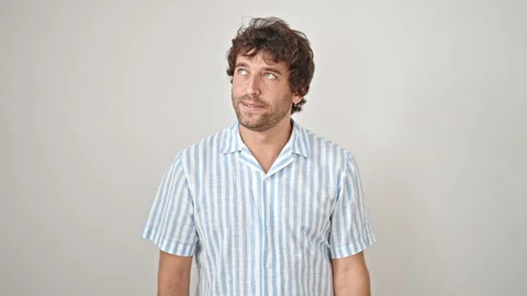 Young hispanic man looking watch with upset expression over isolated white .. Video stock 247379232