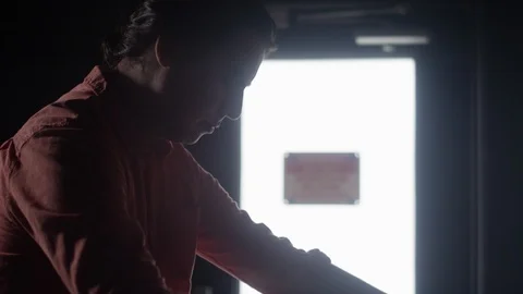 A young hispanic man looks through boxes of vinyl records in a record store Video stock 122595578