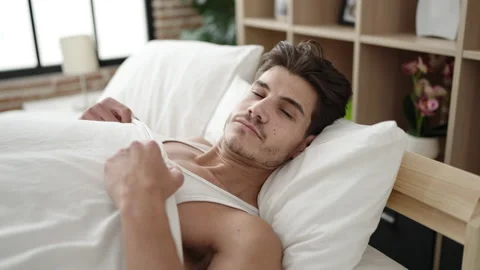 Young hispanic man lying on bed sleeping at bedroom Stock Footage 233417151