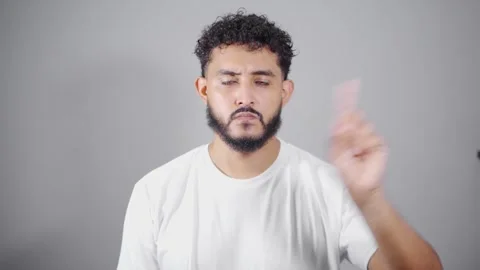 Young hispanic man making various hand gestures on gray background Stock Footage 315051604