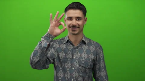 Young hispanic man in patterned shirt isolated against vivid green backgrou.. Stock Footage 308533447