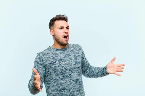 Young hispanic man performing opera or singing at a concert or show, feeling  Stock Photos