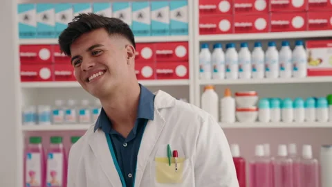 Young hispanic man pharmacist smiling confident standing at pharmacy Video stock 206513352