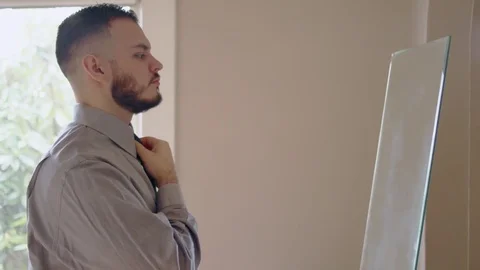 Young hispanic man practicing speech in front of mirror Stock Footage 84484755