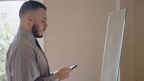 Young hispanic man practicing speech in front of mirror Stock Footage 84486106
