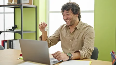 Young hispanic man real state agent having video call holding key of new ho.. Stock Footage 246132201