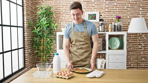Young hispanic man recording cooking tutorial at dinning room Stock Footage 242905784