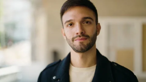 Young hispanic man with relaxed expression standing at street Stock Footage 170655368