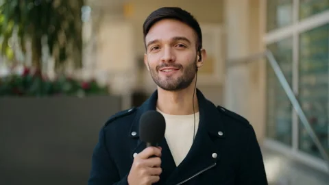 Young hispanic man reporter working using microphone at street Stock Footage 170115508