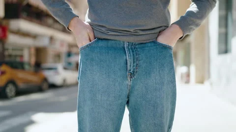 Young hispanic man showing empty pockets at street Stock Footage 194486025