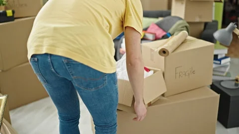 Young hispanic man sitting on sofa relaxing at new home Stock Footage 245044688