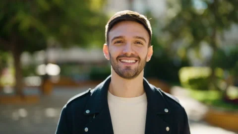 Young hispanic man smiling confident walking at park Stock Footage 169216404