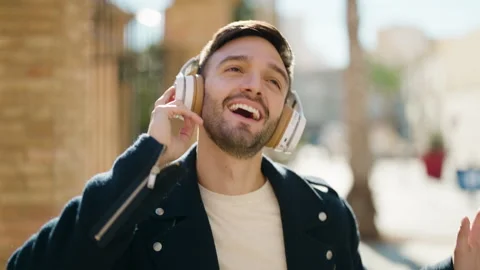 Young hispanic man smiling confident listening to music at street Video stock 170115395