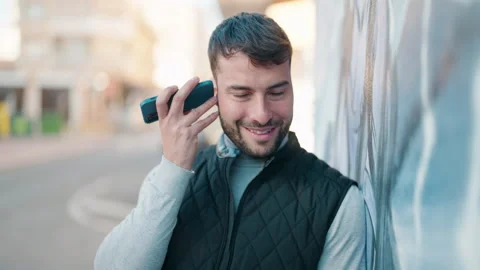 Young hispanic man smiling confident listening audio message by the smartphon Video stock 170654890