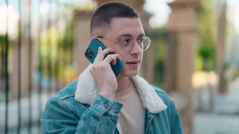 Young hispanic man smiling confident talking on the smartphone at street Stock Footage 171040677
