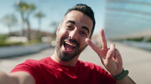 Young hispanic man smiling confident making selfie by the smartphone at stree Video stock 171067242