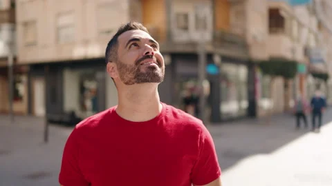 Young hispanic man smiling confident looking to the sky at street Video stock 171816266