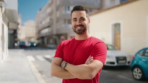 Young hispanic man smiling confident standing with arms crossed gesture at st Stock Footage 171816428