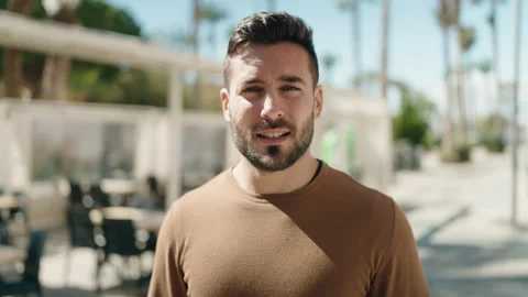 Young hispanic man smiling confident speaking at street Video stock 172054540