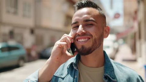 Young hispanic man smiling confident talking on the smartphone at street Stock-Footage 206553704