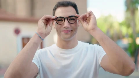 Young hispanic man smiling confident wearing glasses at street Video stock 231501729
