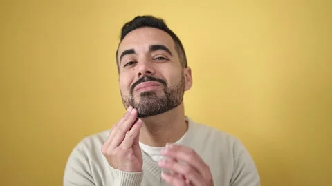 Young hispanic man smiling confident touching beard with hands over isolate.. Stock Footage 232876251