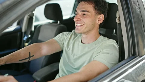 Young hispanic man smiling confident driving car at street Video stock 243482050