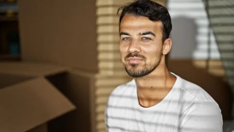 Young hispanic man smiling confident sitting on sofa at new home Video stock 245030992