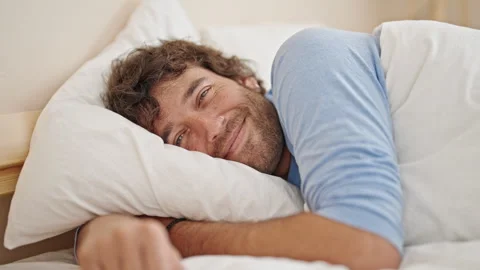 Young hispanic man smiling confident lying on bed at bedroom Video stock 246132307