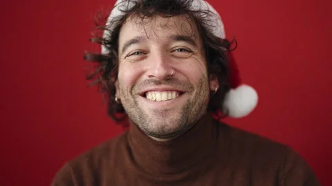 Young hispanic man smiling confident wearing christmas hat over isolated re.. Video stock 246132705