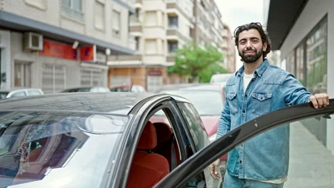 Young hispanic man smiling confident opening car door at street Video stock 247378189