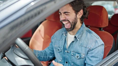 Young hispanic man smiling confident driving car celebrating at street Video stock 247378219