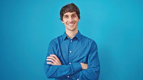 Young hispanic man smiling confident standing with arms crossed gesture ove.. Video stock 247385035