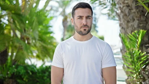 Young hispanic man standing with serious expression saying no with head at pa Stock Footage 243489595