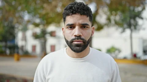 Young hispanic man standing with serious expression saying no with head at pa Video stock 245046098