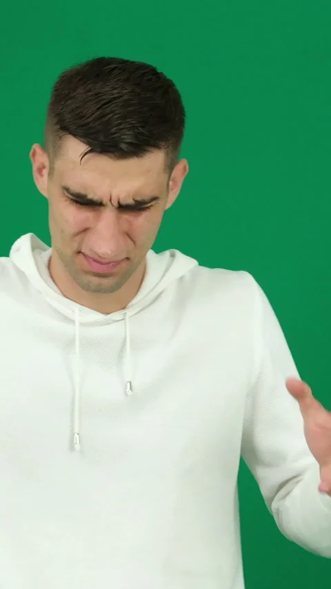 Young hispanic man standing, wearing shirt, face displaying disgusted expression Stock Footage 278444872